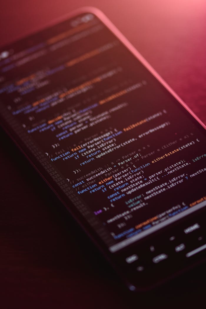 Colorful code displayed on a smartphone screen with a warm glow.